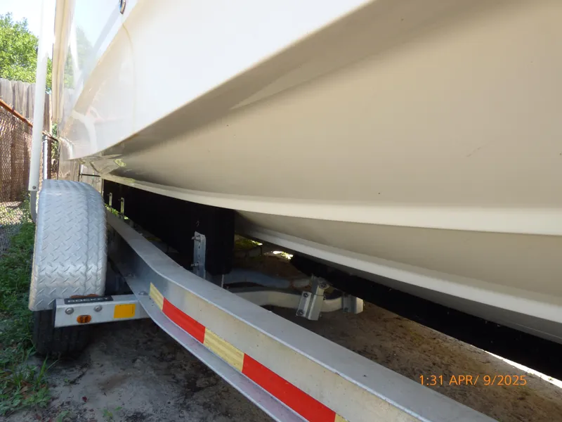 Slide: The Image of 2018 Boston Whaler 250 Outrage on trailer, side view showing hull and wheels. - 11