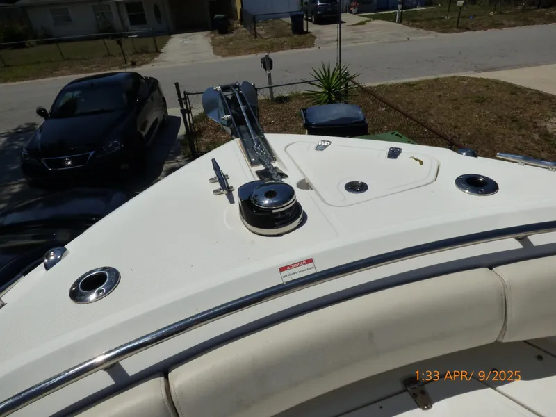 Slide: The Image of 2018 Boston Whaler 250 Outrage boat deck with anchor and seating, parked in residential area. - 22