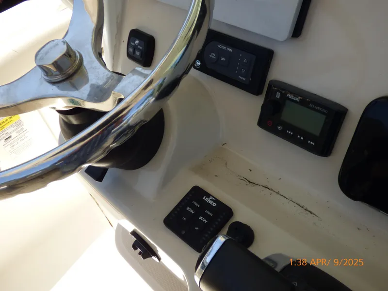 Slide: The Image of Steering wheel and controls of a 2018 Boston Whaler 250 Outrage boat. - 38