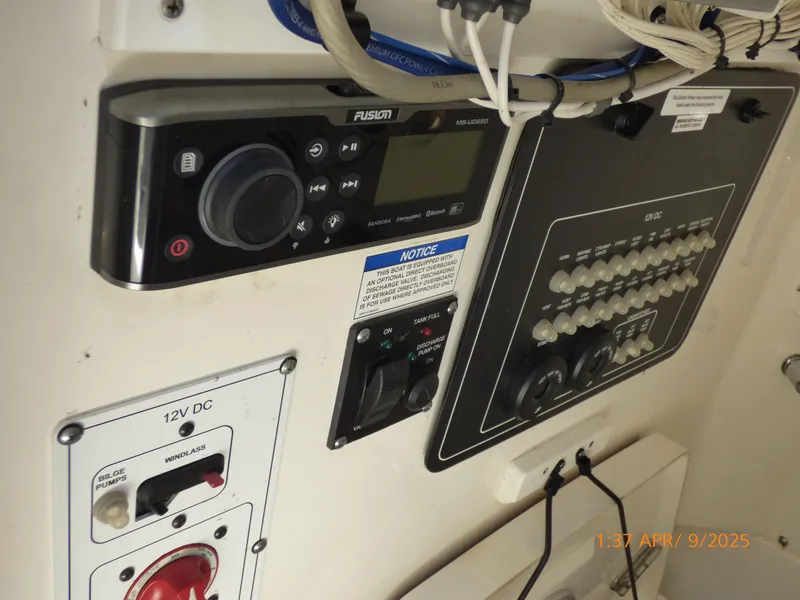 Slide: The Image of Control panel of a 2018 Boston Whaler 250 Outrage boat with audio system and switches. - 31