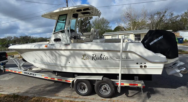 Slide: The Image of 2018 Boston Whaler 250 Outrage boat on trailer, side view, outdoors. - 3