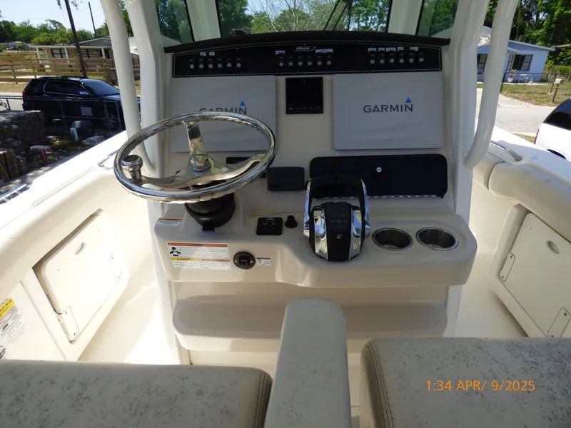 Slide: The Image of 2018 Boston Whaler 250 Outrage helm with Garmin electronics and steering wheel. - 25