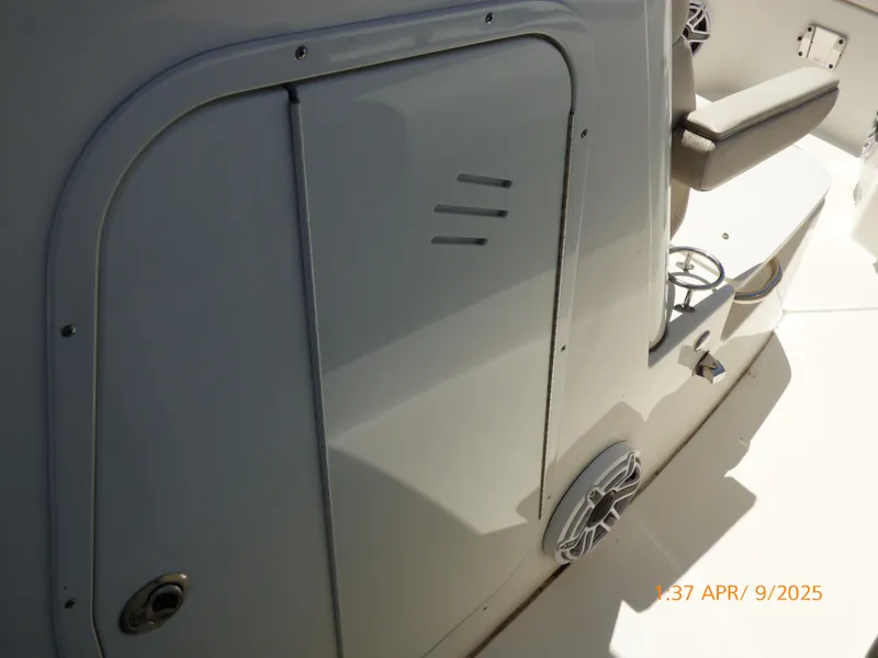 Slide: The Image of 2018 Boston Whaler 250 Outrage boat interior, featuring storage compartment and seating area. - 33