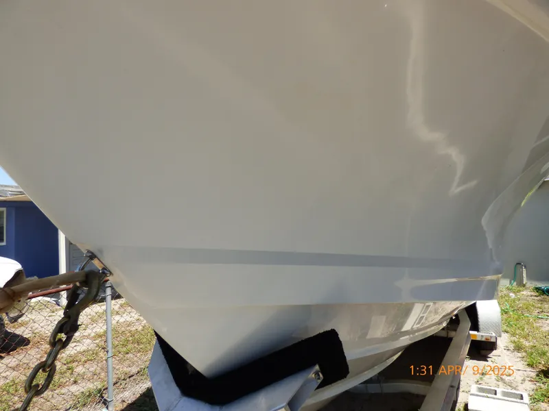 Slide: The Image of 2018 Boston Whaler 250 Outrage boat hull on trailer, close-up view. - 13