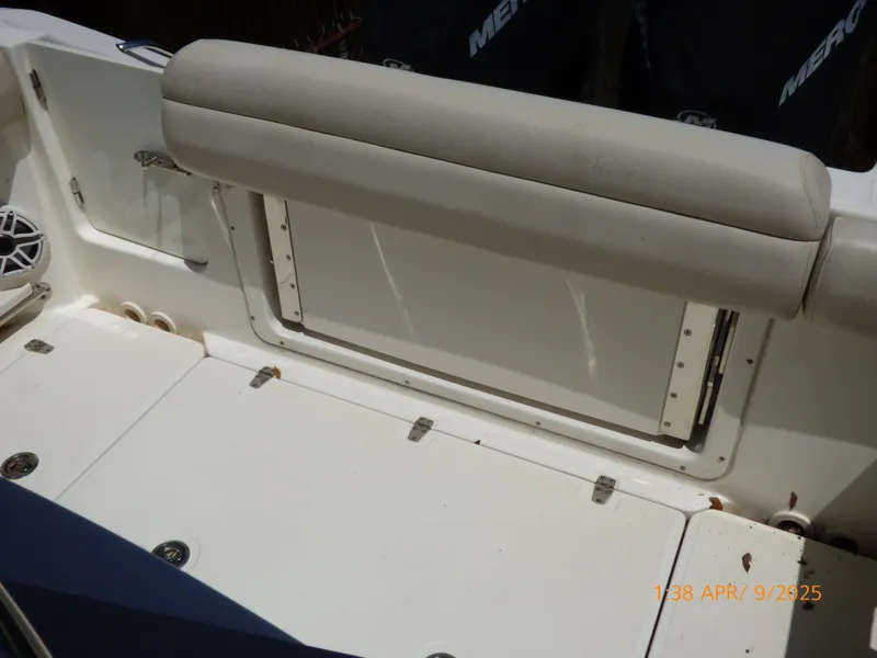 Slide: The Image of 2018 Boston Whaler 250 Outrage boat interior with cushioned seating and storage compartment. - 36