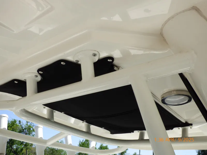 Slide: The Image of 2018 Boston Whaler 250 Outrage T-top frame with black canvas and light fixture. - 28