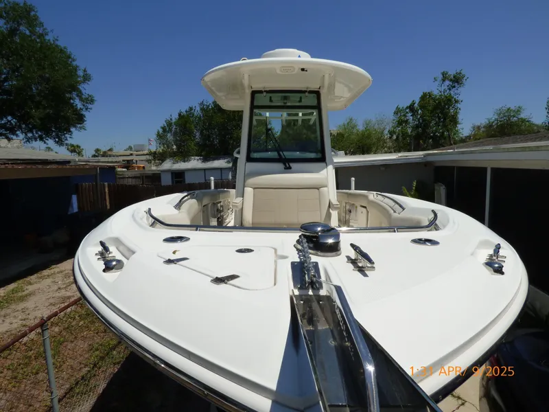 Slide: The Image of 2018 Boston Whaler 250 Outrage boat, front view, docked outdoors. - 14