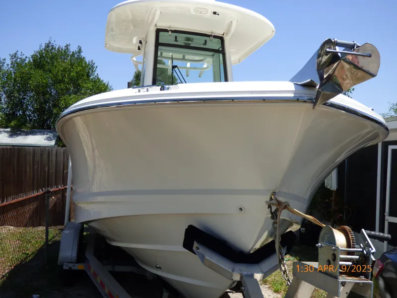 Slide: The Image of 2018 Boston Whaler 250 Outrage boat on trailer, front view, sunny day. - 8
