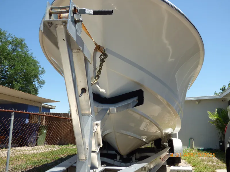 Slide: The Image of 2018 Boston Whaler 250 Outrage boat on trailer, viewed from below, outdoors. - 12