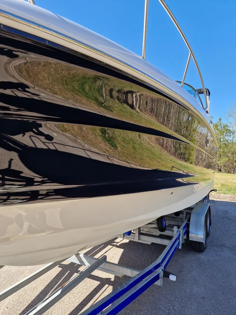 Slide: The Image of 2006 Monterey 270 Cruiser boat on trailer, reflecting clear blue sky. - 11