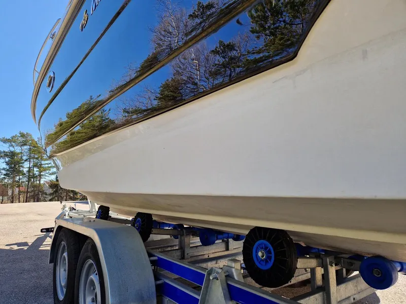 Slide: The Image of 2006 Monterey 270 Cruiser on trailer, reflecting trees and sky. - 12