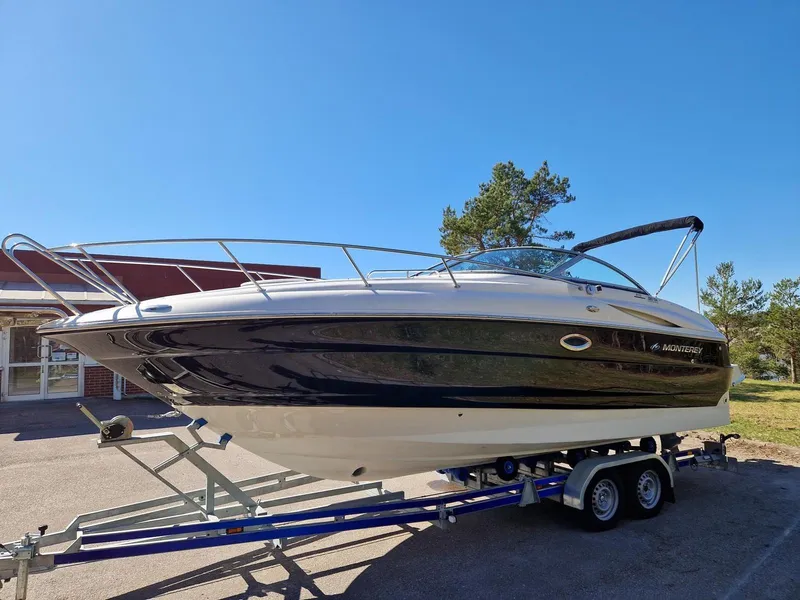 Slide: The Image of 2006 Monterey 270 Cruiser boat on trailer under clear blue sky. - 2