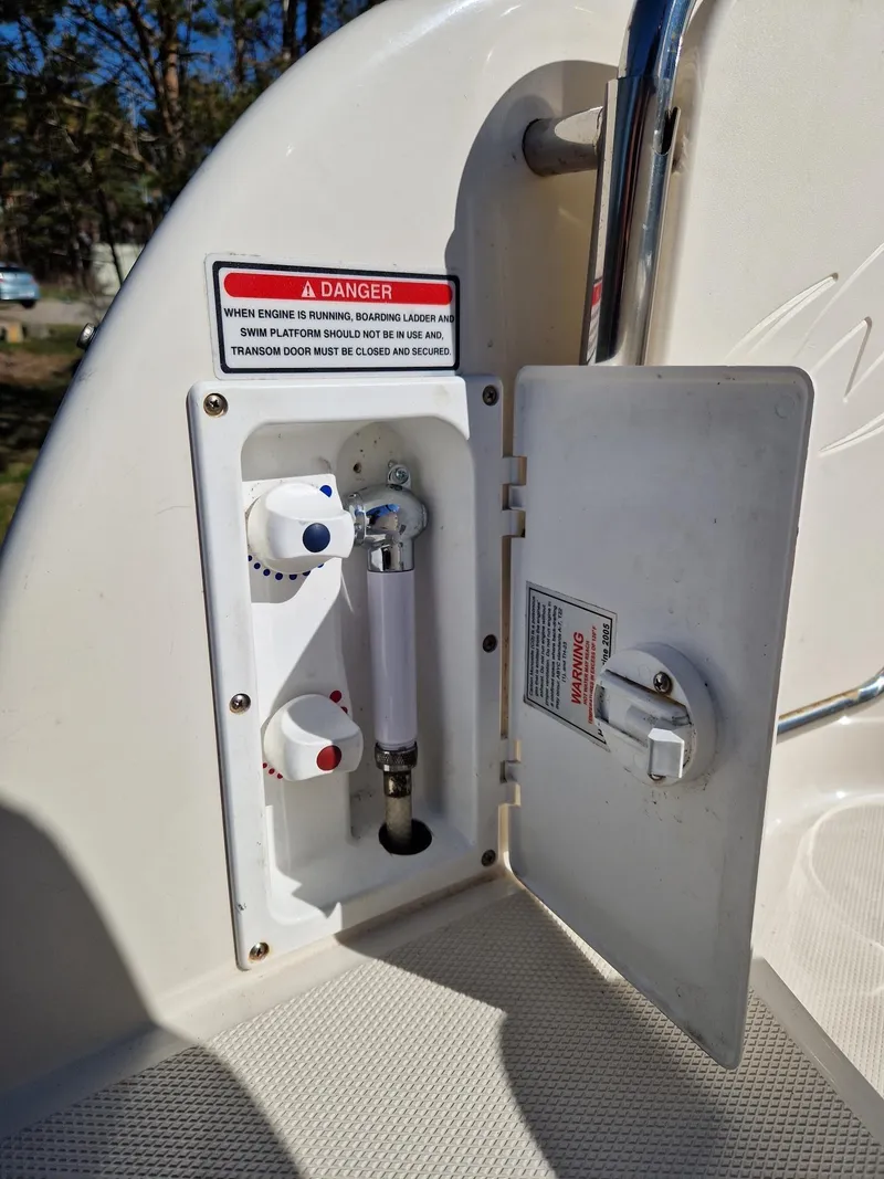 Slide: The Image of 2006 Monterey 270 Cruiser control panel with safety warning and open compartment. - 21