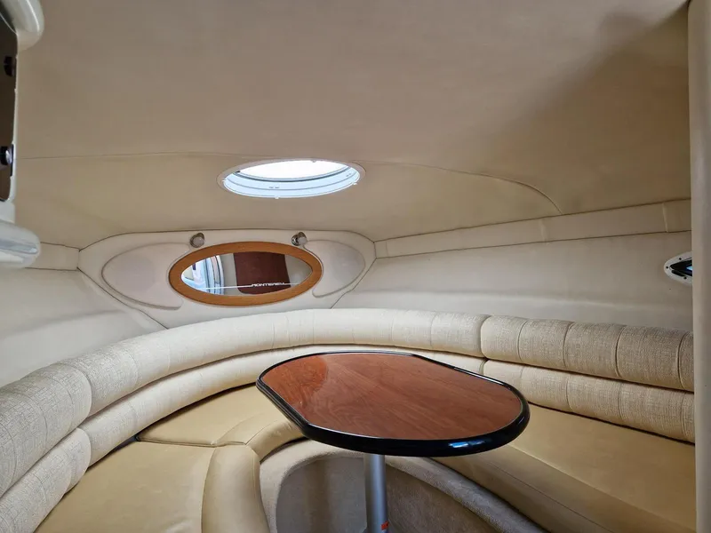 Slide: The Image of Interior of 2006 Monterey 270 Cruiser with beige seating and wooden table. - 24