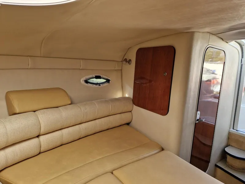 Slide: The Image of Interior of 2006 Monterey 270 Cruiser with beige seating and wooden accents. - 26