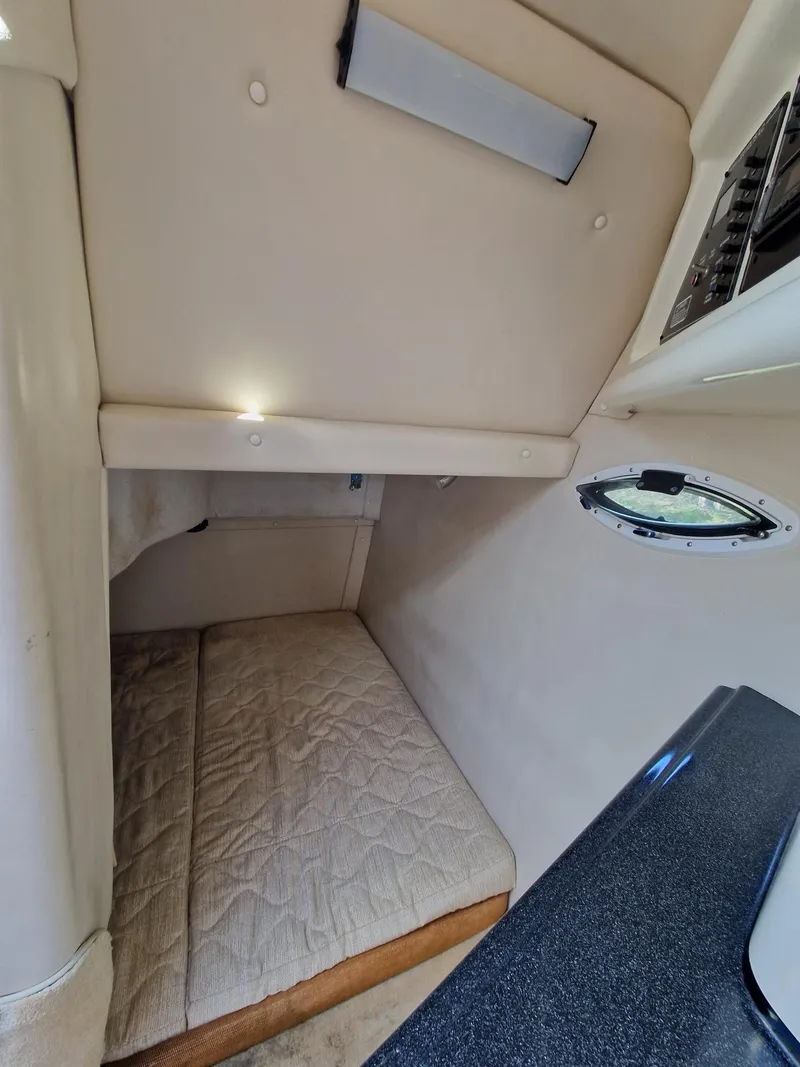Slide: The Image of Interior cabin of a 2006 Monterey 270 Cruiser with a cozy sleeping area. - 27