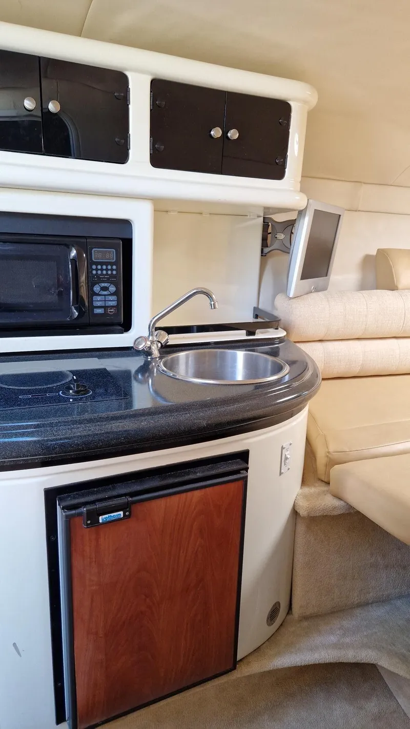 Slide: The Image of 2006 Monterey 270 Cruiser interior with kitchenette, sink, and seating area. - 28