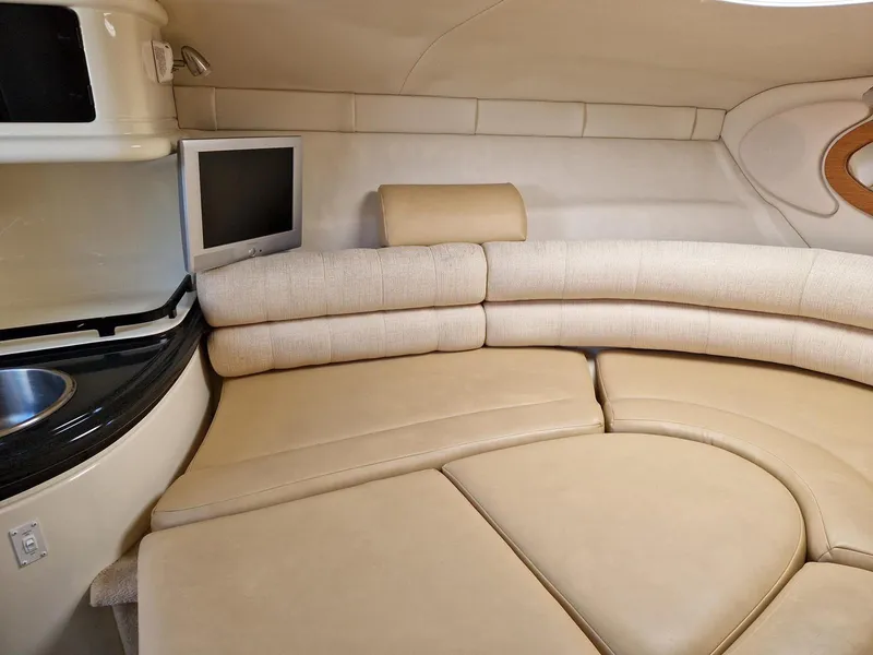 Slide: The Image of Interior of 2006 Monterey 270 Cruiser with beige seating and compact TV. - 29
