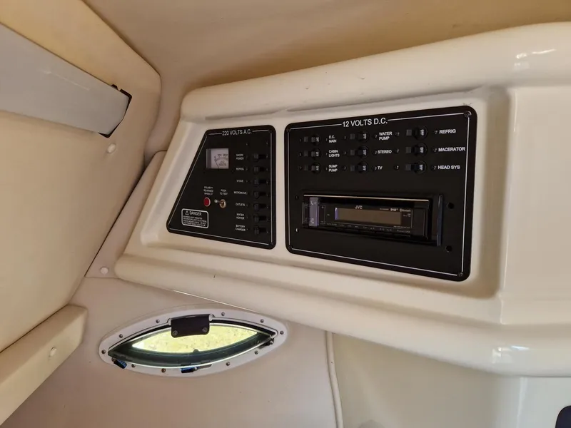 Slide: The Image of Control panel inside 2006 Monterey 270 Cruiser boat cabin with AC and DC switches. - 30