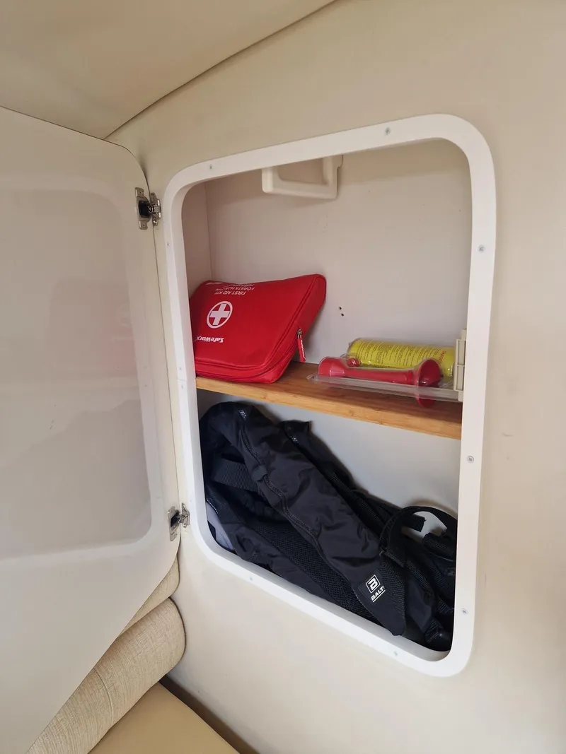 Slide: The Image of Storage compartment in a 2006 Monterey 270 Cruiser with first aid kit and backpack. - 34