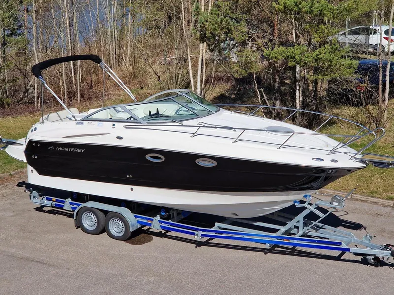 Slide: The Image of 2006 Monterey 270 Cruiser boat on trailer, parked outdoors. - 6