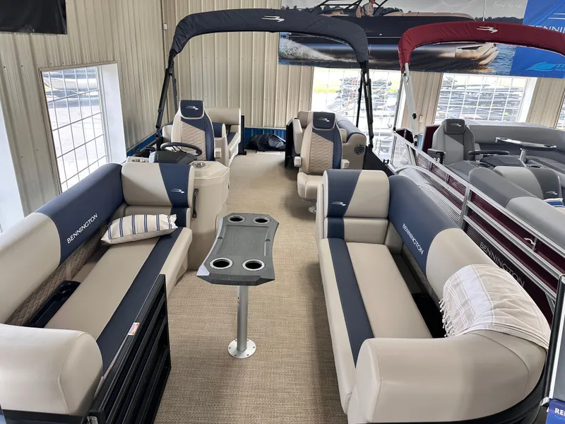 Slide: The Image of 2024 Bennington S Series 22 SSR pontoon boat interior with plush seating and table. - 3