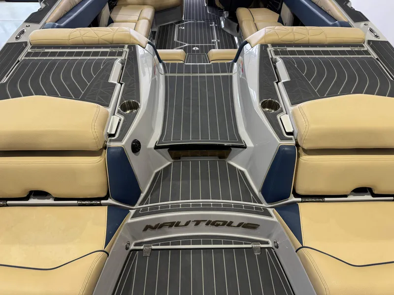 Slide: The Image of 2022 Nautique Super Air Nautique G23 Paragon interior with beige and blue seating. - 11