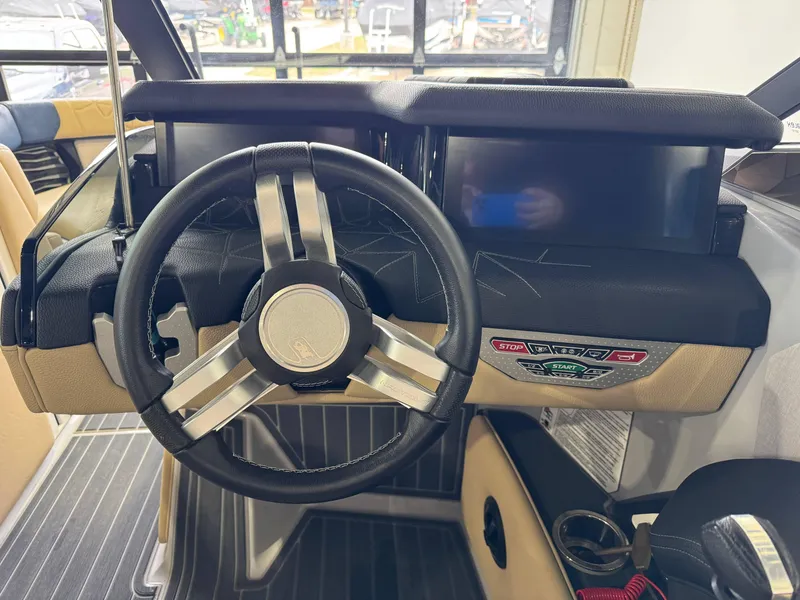 Slide: The Image of 2022 Nautique Super Air Nautique G23 Paragon steering wheel and dashboard controls. - 29