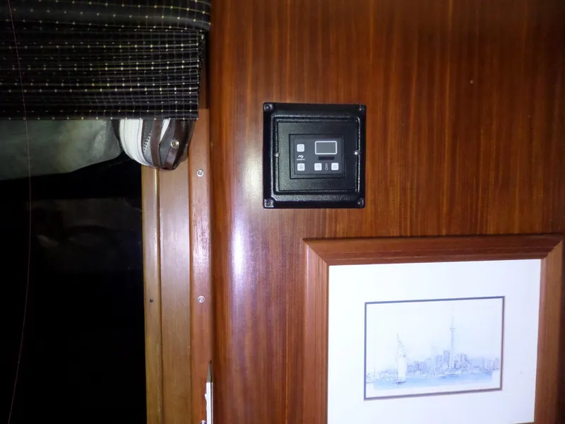 Slide: The Image of Interior of 1988 Hatteras 38 Convertible with control panel and framed artwork. - 12