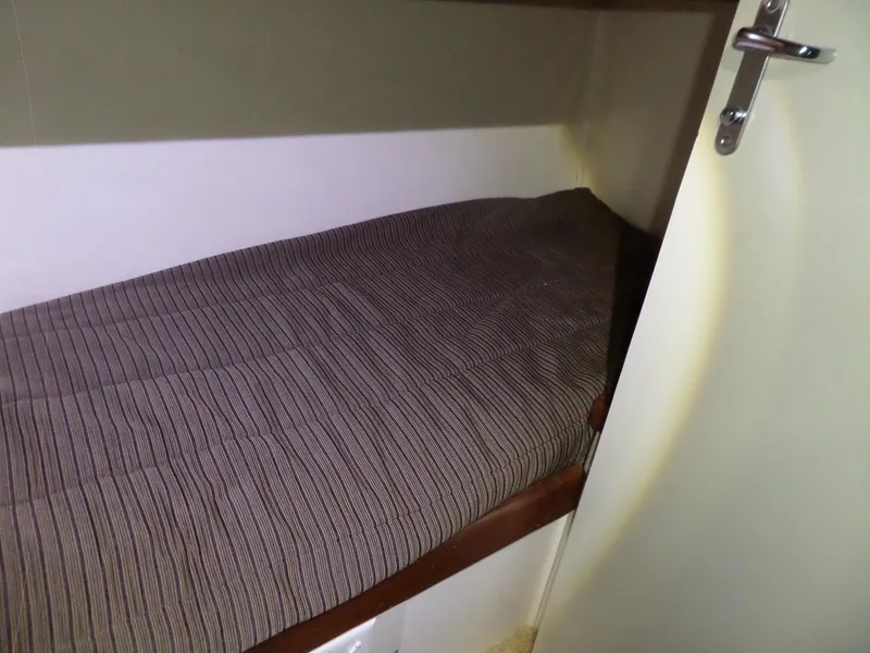 Slide: The Image of Interior cabin of 1988 Hatteras 38 Convertible with a cozy bed. - 18