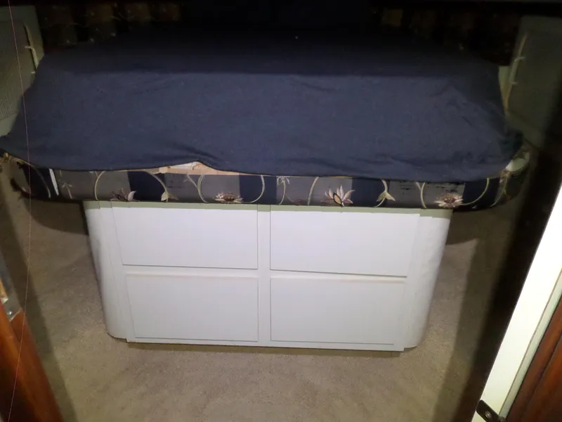 Slide: The Image of Interior cabin of 1988 Hatteras 38 Convertible with bed and storage drawers. - 22