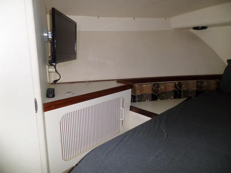 Slide: The Image of 1988 Hatteras 38 Convertible cabin interior with TV and bed. - 23