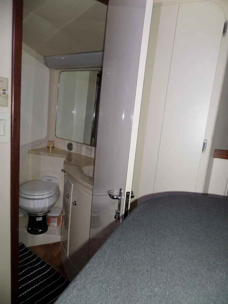 Slide: The Image of 1988 Hatteras 38 Convertible yacht interior bathroom with modern fixtures and striped rug. - 28