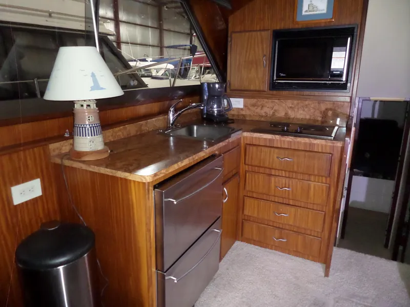 Slide: The Image of Interior of 1988 Hatteras 38 Convertible yacht kitchen with wood cabinetry and modern appliances. - 3