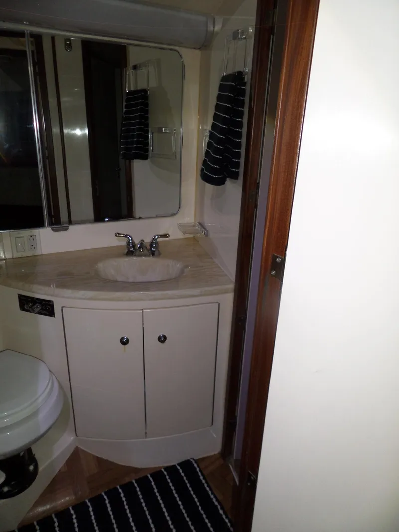 Slide: The Image of Bathroom interior of 1988 Hatteras 38 Convertible yacht with sink and mirror. - 30