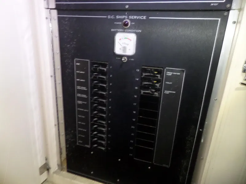 Slide: The Image of Electrical panel on 1988 Hatteras 38 Convertible boat, featuring circuit breakers and battery condition gauge. - 34