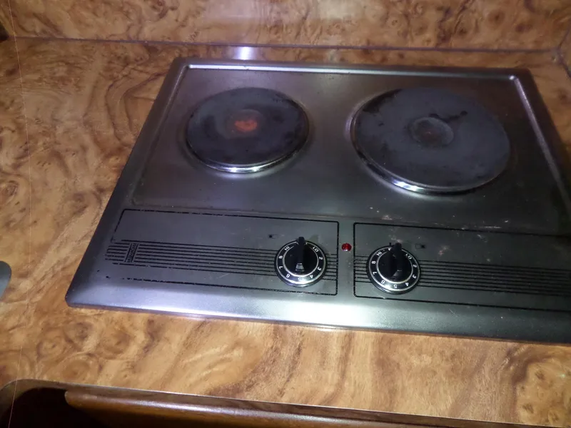 Slide: The Image of Electric stove on Hatteras 38 Convertible yacht, 1988 model, with two burners and wooden countertop. - 36