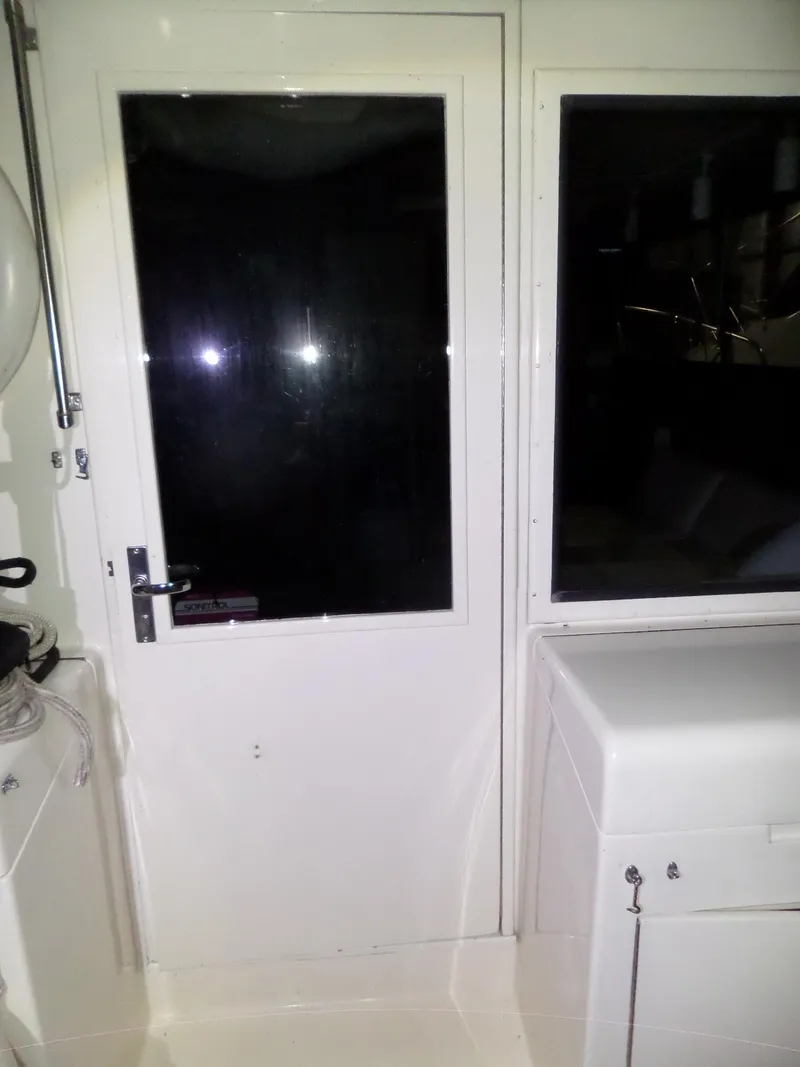 Slide: The Image of 1988 Hatteras 38 Convertible yacht interior with door and window. - 39