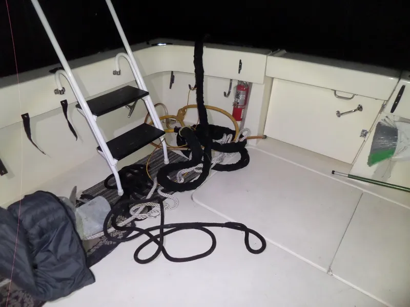 Slide: The Image of 1988 Hatteras 38 Convertible boat deck with ladder and coiled ropes. - 43