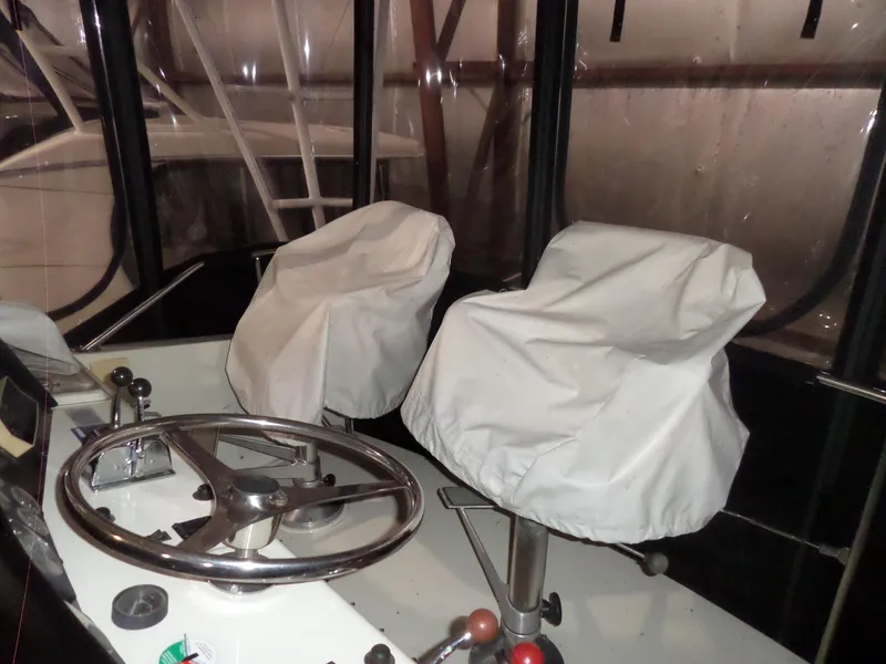 Slide: The Image of Helm of 1988 Hatteras 38 Convertible with covered seats and steering wheel. - 46