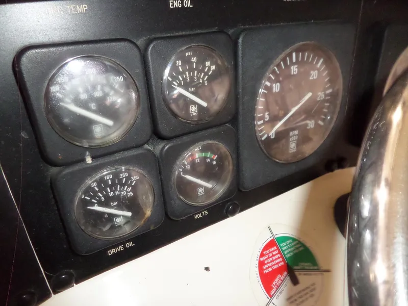 Slide: The Image of Instrument panel of 1988 Hatteras 38 Convertible boat showing gauges and dials. - 49
