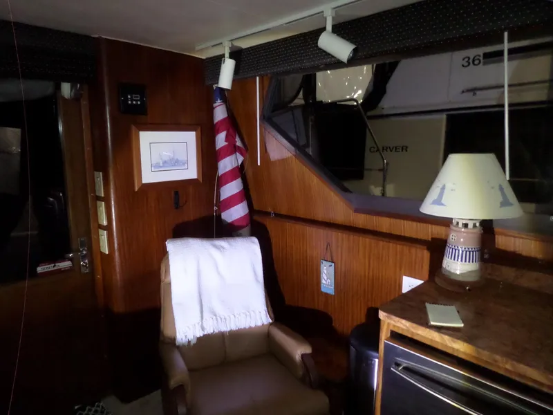 Slide: The Image of Interior of 1988 Hatteras 38 Convertible yacht with cozy seating and nautical decor. - 8