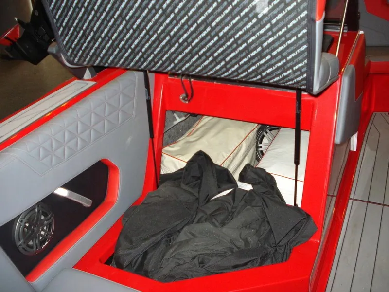 Slide: The Image of 2023 Nautique Super Air Nautique GS22 interior storage compartment with red and gray accents. - 4