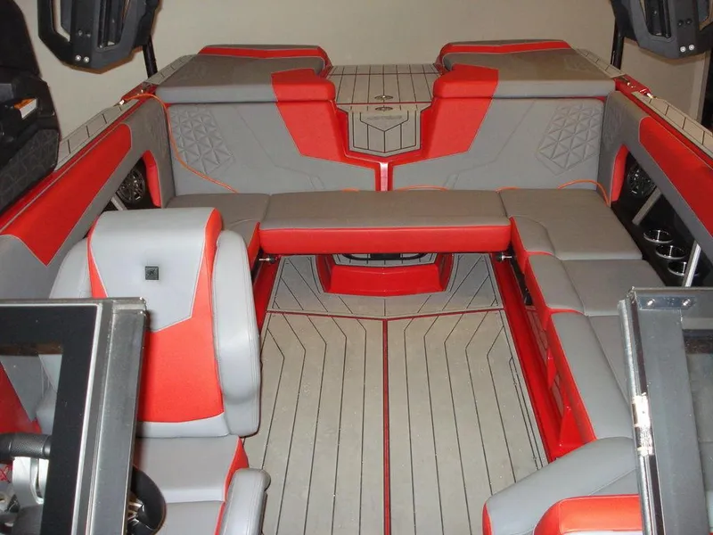 Slide: The Image of 2023 Nautique Super Air Nautique GS22 interior with red and gray seating. - 5