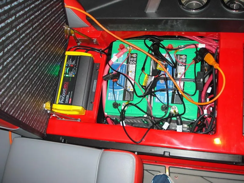 Slide: The Image of 2023 Nautique Super Air Nautique GS22 battery compartment with wiring and charger. - 6
