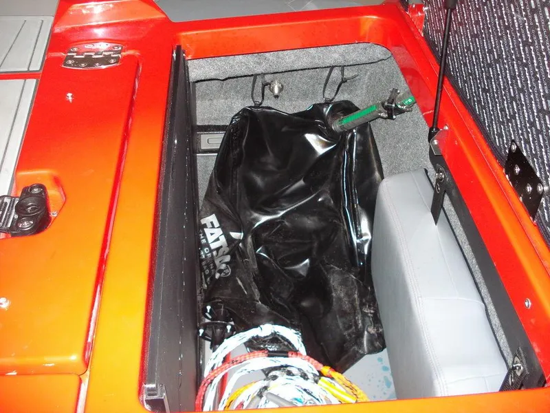 Slide: The Image of 2023 Nautique Super Air Nautique GS22 storage compartment with equipment and accessories. - 7