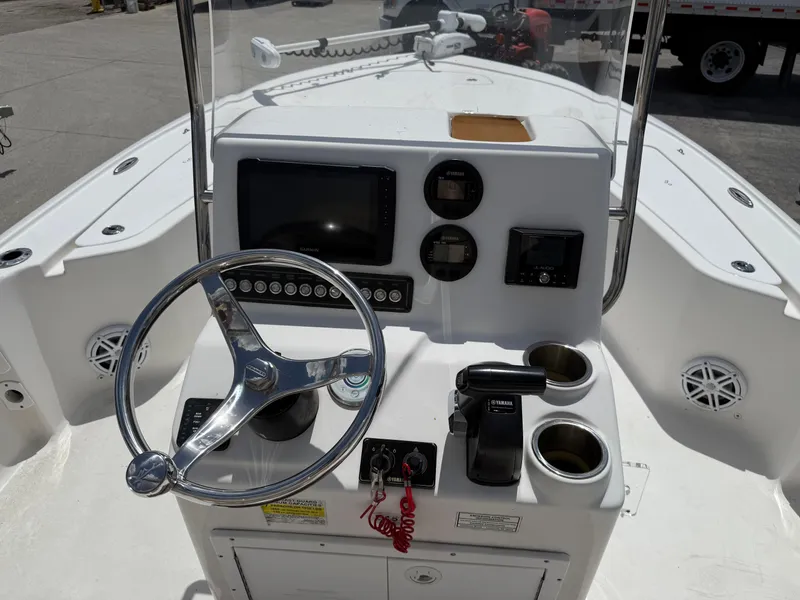 Slide: The Image of 2022 Tidewater 1910 Bay Max boat console with steering wheel and navigation controls. - 12