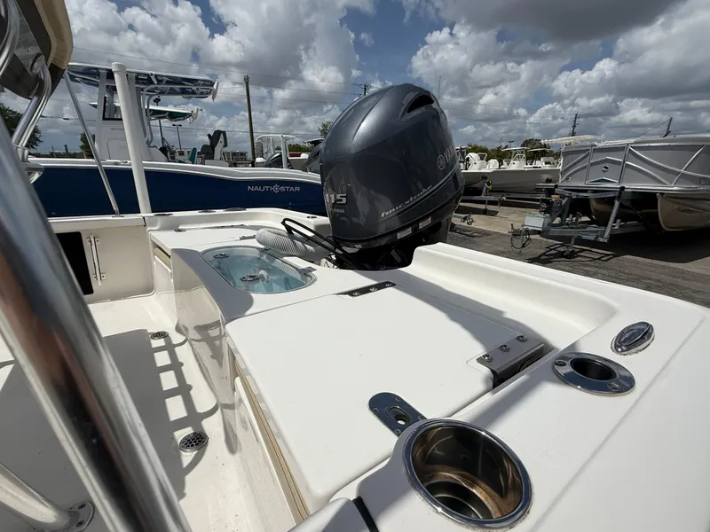Slide: The Image of 2022 Tidewater 1910 Bay Max boat with Yamaha outboard motor, docked under cloudy skies. - 6