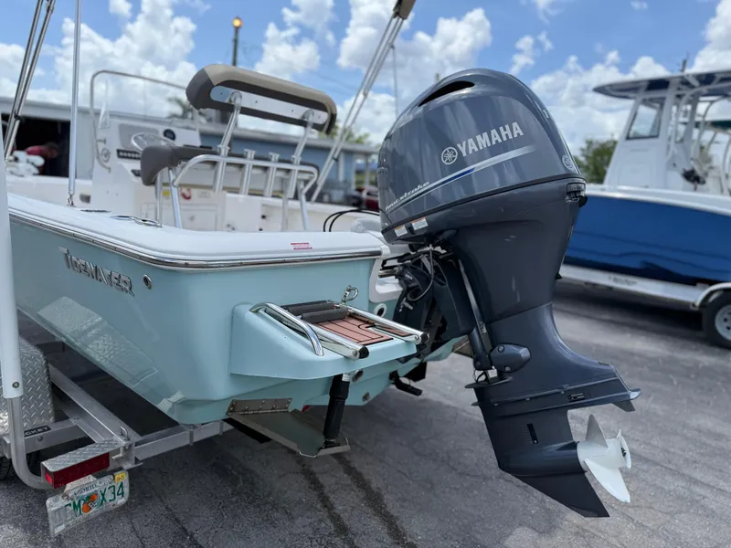 Slide: The Image of Tidewater 1910 Bay Max boat with Yamaha outboard motor, parked on a trailer. - 9