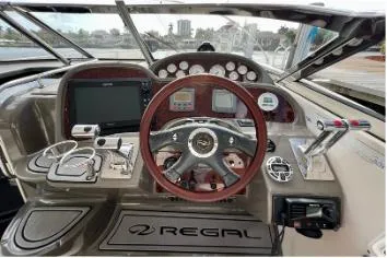 Slide: The Image of 2007 Regal Commodore 3760 IB helm with steering wheel, gauges, and navigation equipment. - 3